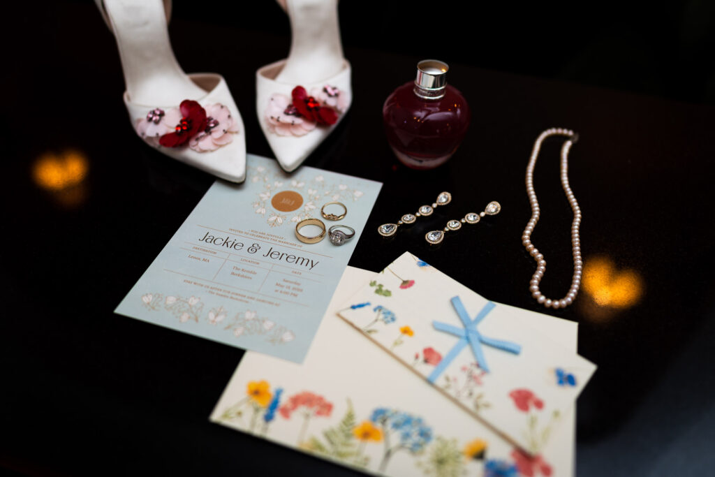 detail portrait with wedding shoes stationary earrings perfume pearl necklace and rings